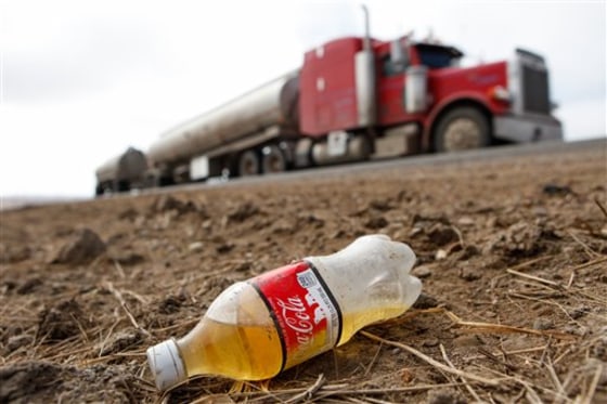 A discarded bottle filled with urine sits along Highway 85 near Williston, N.D., last Friday. As the number of trucks coming to the oil mecca increases, so does the trash.